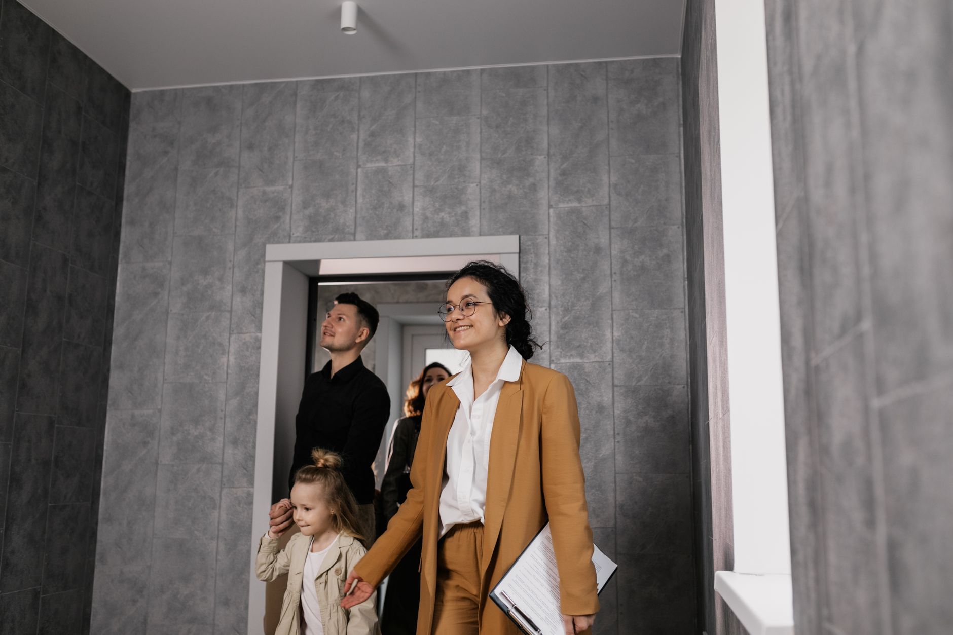 An agent showing a family around a prospective home